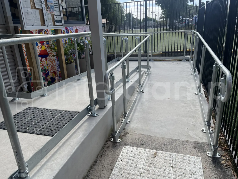 Interclamp disability compliant galvanised handrail with toeboard installed at a kindergarten